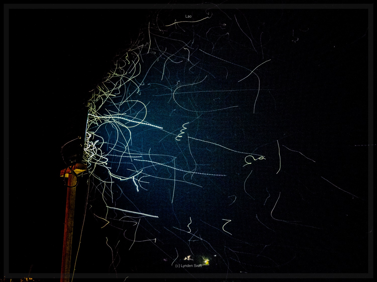  Fly trails caught in arc light, Luang Prabang, Lao. Lynden Swift. Tangible Presence Photography. 